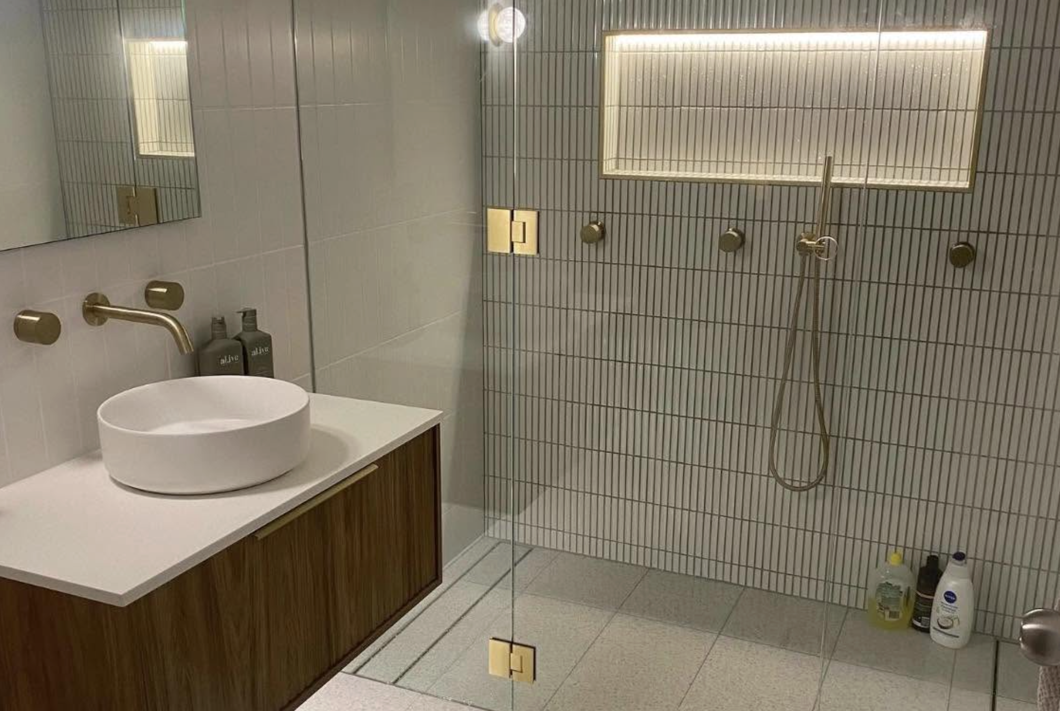 Completed bathroom renovation with brushed brass tapware